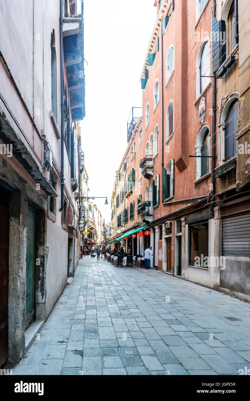 restaurants and people eating in the street called 'dei Boteri' in Venice, Italy Stock Photo