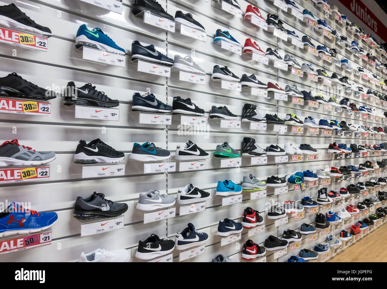 Racks of trainers on display in a sports store Stock Photo - Alamy