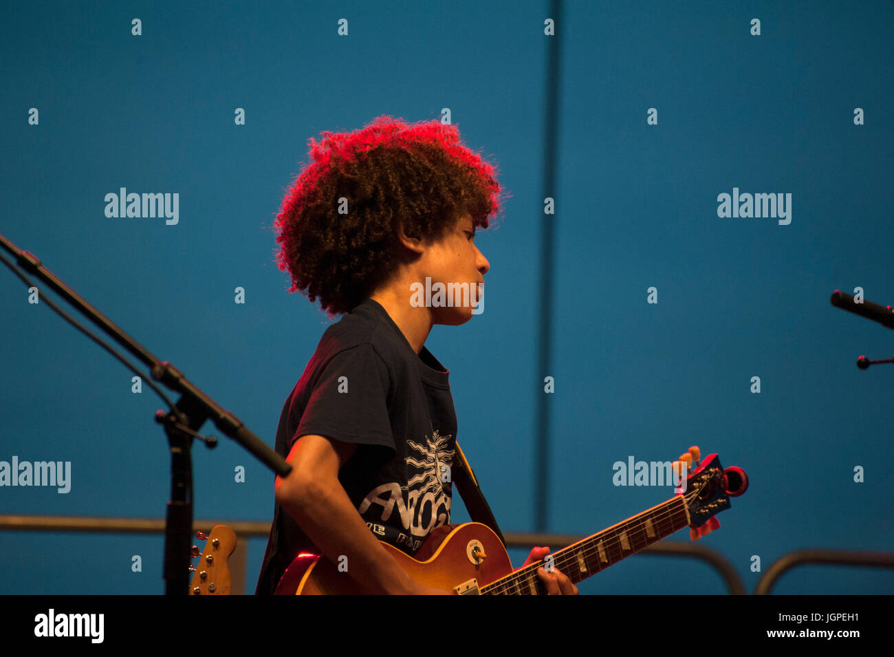 Brandon Niederauer “Taz,” a 14-year-old guitarist and vocalist, played with the Los Lobos band during a blues concert in Battery Park City, Manhattan. Stock Photo
