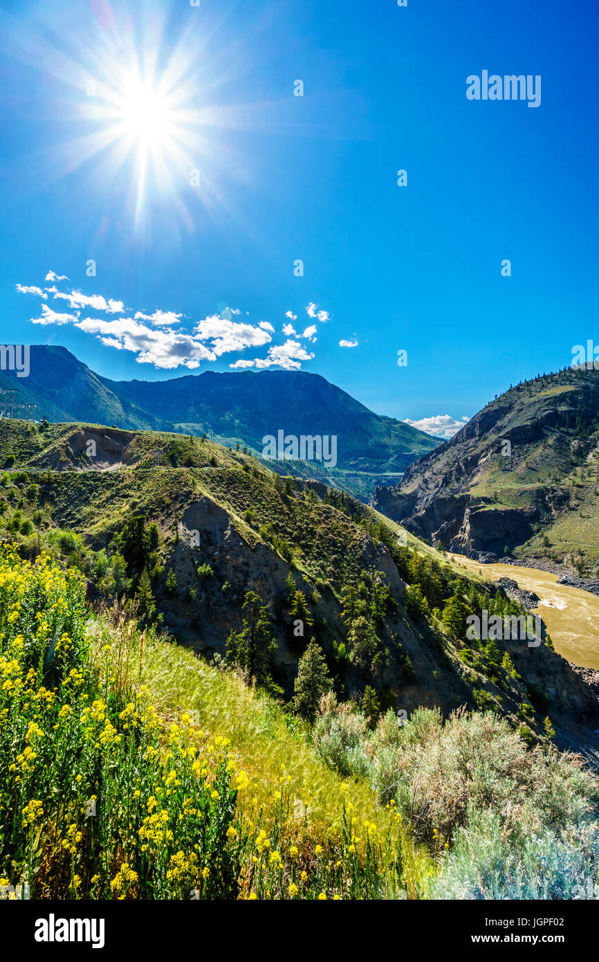 Sun Rays over the Fraser River as it flows to the town of Lillooet in the Chilcotin region on British Columbia Stock Photo