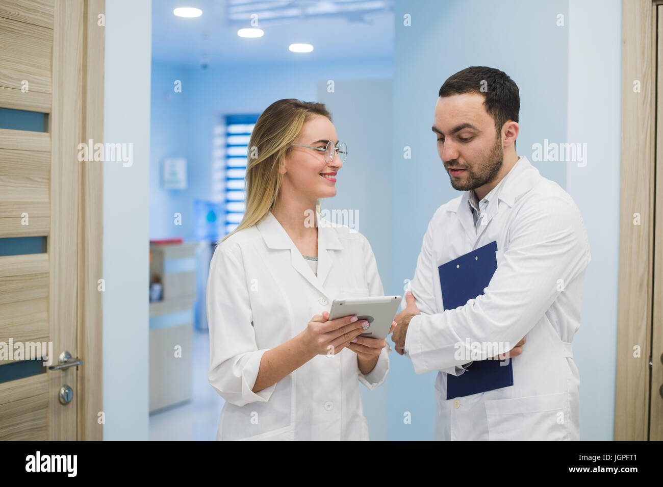 Two doctors discussing diagnosis while walking Stock Photo