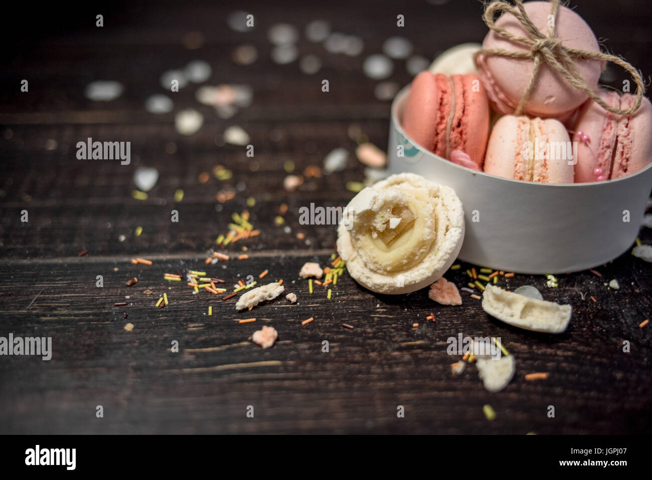 Multi color pastel macaroons in white deep plate decorated with rope ...
