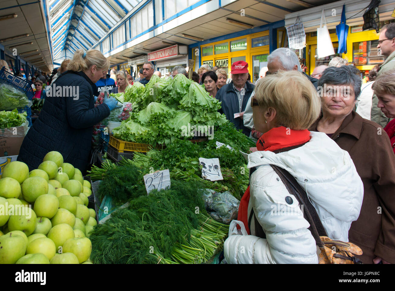 Shoppers at a produce market in Sofia look for vegetables. Stock Photo