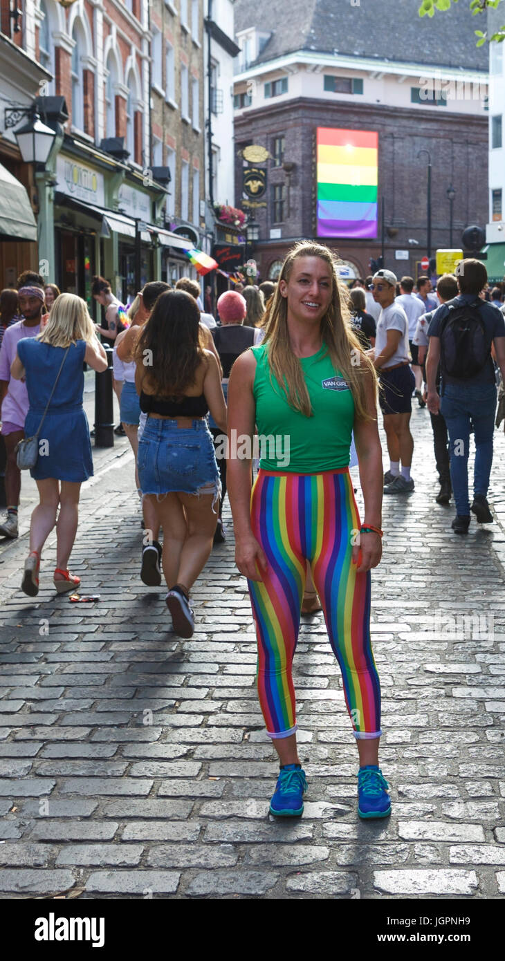 A Soho street scene London.  Fit young woman wearing LGBT leggings enjoying the Soho street party atmosphere, after Gay Pride, the annual Pride London Stock Photo