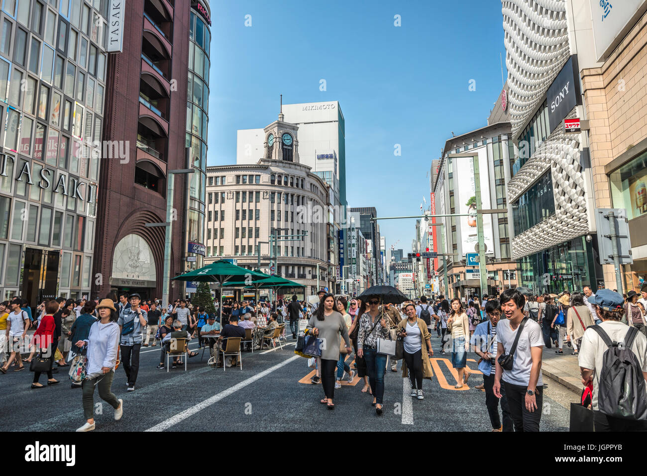 Tourists and locals are walking at a traffic free Sunday over Ginza Street, Tokyo, Japan Stock Photo