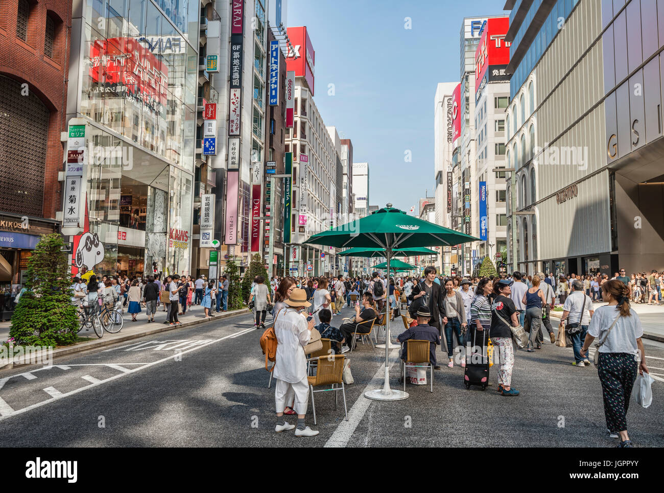 Tourists and locals are walking at a traffic-free Sunday over Ginza Street, Tokyo, Japan Stock Photo