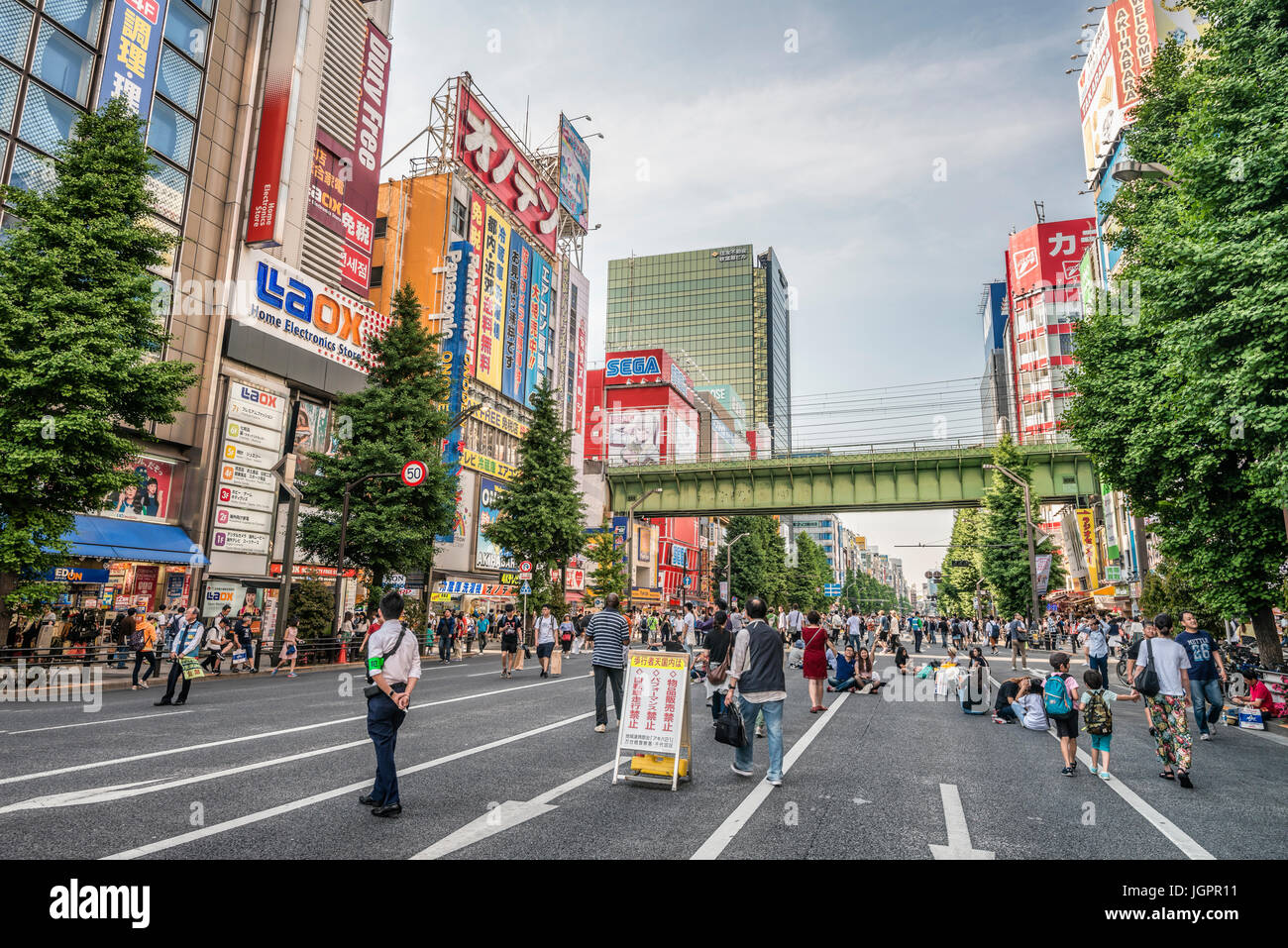 Tourists and locals are walking at a traffic free Sunday over the Chuo-Dori shopping street at the Akihabara Electric Town, Tokyo, Japan Stock Photo