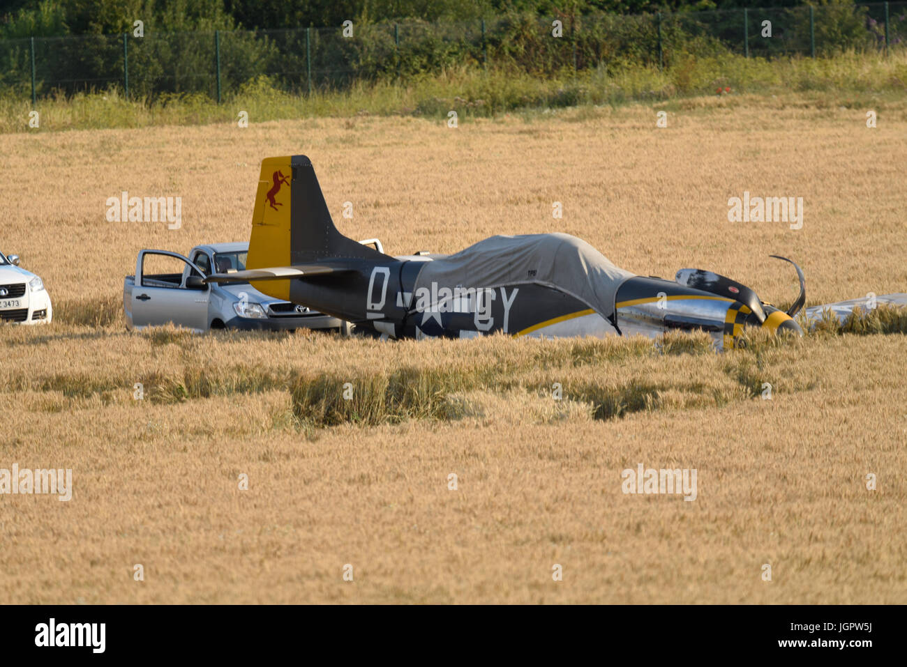 The pilot of a wartime North American P-51 Mustang fighter plane named 'Miss Velma' made a successful forced landing into a field after suffering engine failure upon completion of a display at an airshow Stock Photo