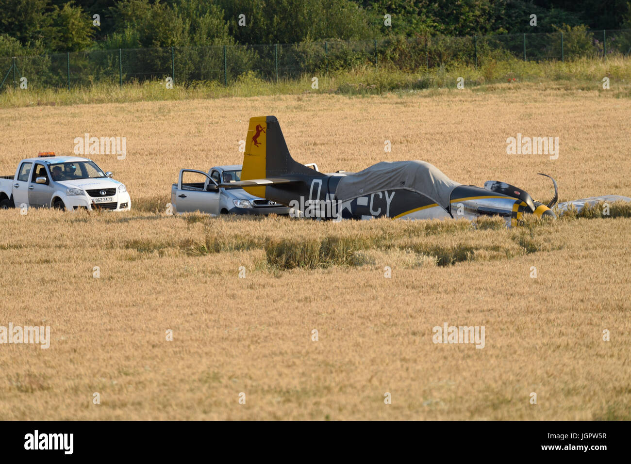 The pilot of a wartime North American P-51 Mustang fighter plane named 'Miss Velma' made a successful forced landing into a field after suffering engine failure upon completion of a display at an airshow Stock Photo
