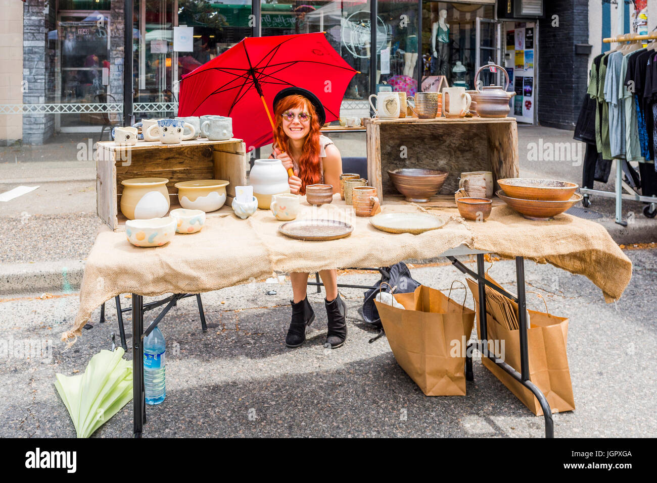 Vancouver, Canada. 9th Jul, 2017. Young woman with pottery booth, Car Free Day, Commercial Drive, Vancouver, British Columbia, Canada. Credit: Michael Wheatley/17�Թ����� Live News Stock Photo