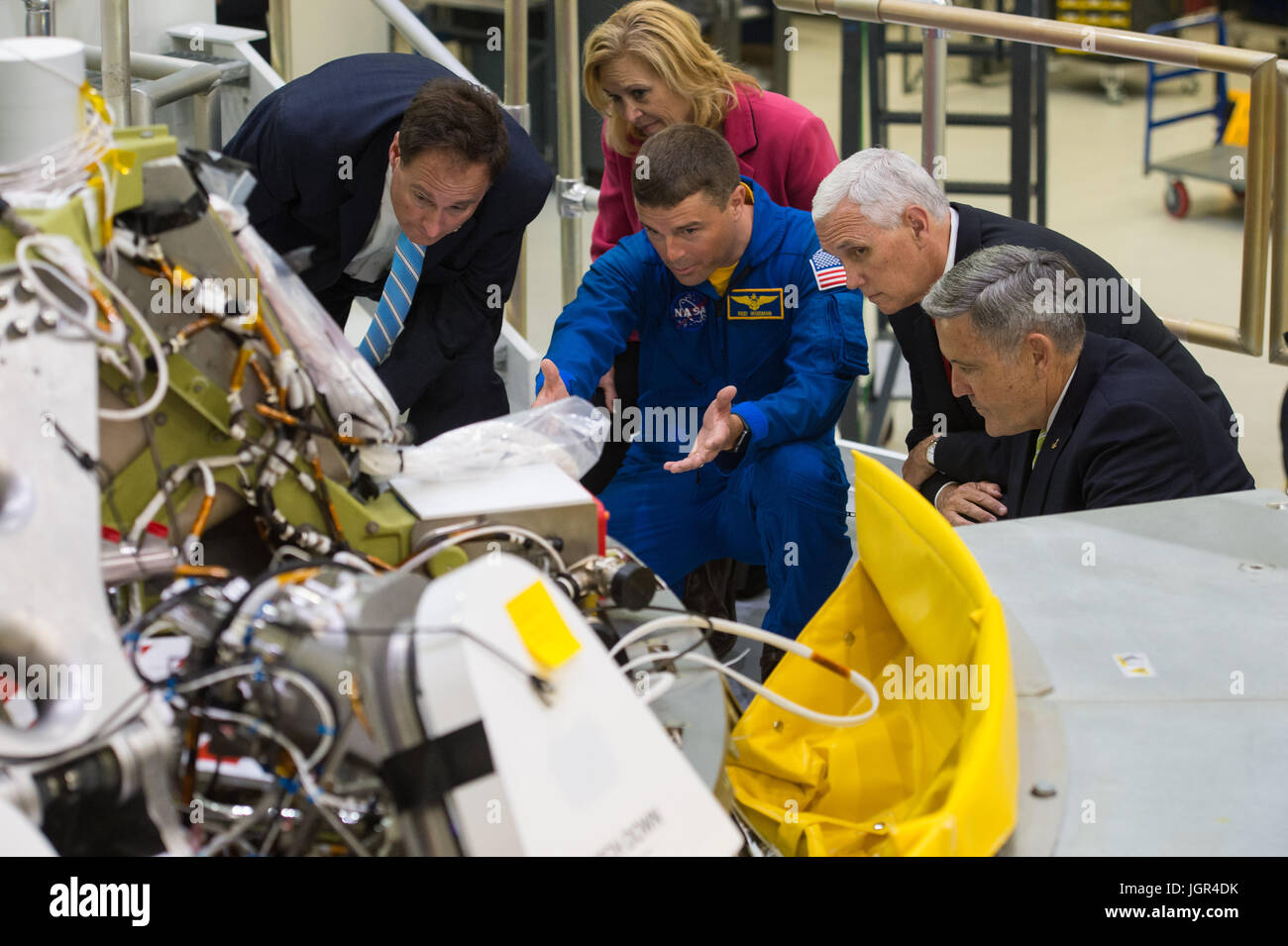 In this photo released by the National Aeronautics and Space Administration (NASA) United States Vice President Mike Pence, second from right; NASA Acting Administrator Robert Lightfoot, left; Deputy Director, Kennedy Space Center, Janet Petro, second from left; NASA astronaut Reid Wiseman, center; and Director, Kennedy Space Center (KSC), Robert Cabana, right, look at the Orion capsule that will fly on the first integrated flight with the Space Launch System rocket in 2019, during a tour of the Kennedy Space Center's (KSC) Operations and Checkout Building on Thursday, July 6, 2017 in Cape Can Stock Photo