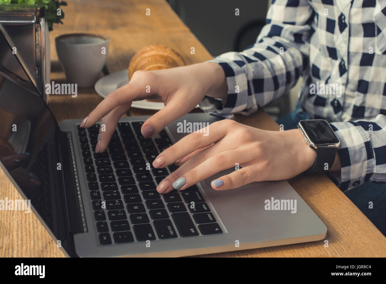 Young woman work using laptop in a coffee shop Stock Photo - Alamy