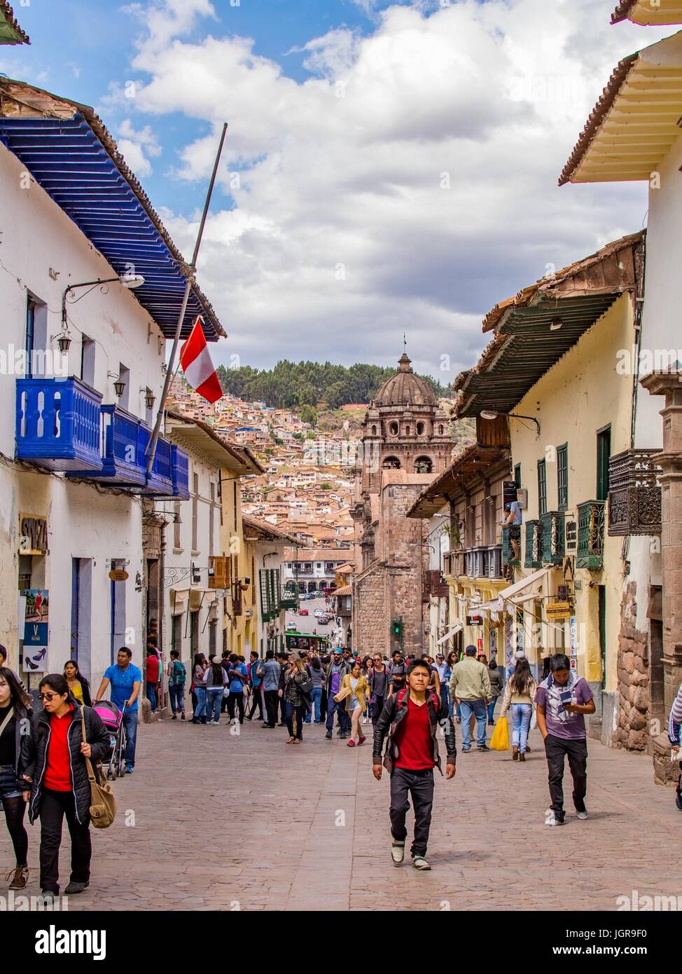 Cusco Peru street with people and a Peruvian flag in Cuzco Peru, South America. Stock Photo