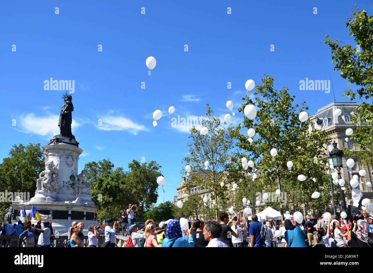 PARIS - AUG 7:  Protesters release balloons at an anti-nuclear weapon rally at the Place de la Republique in Paris, France on August 7, 2016. Stock Photo