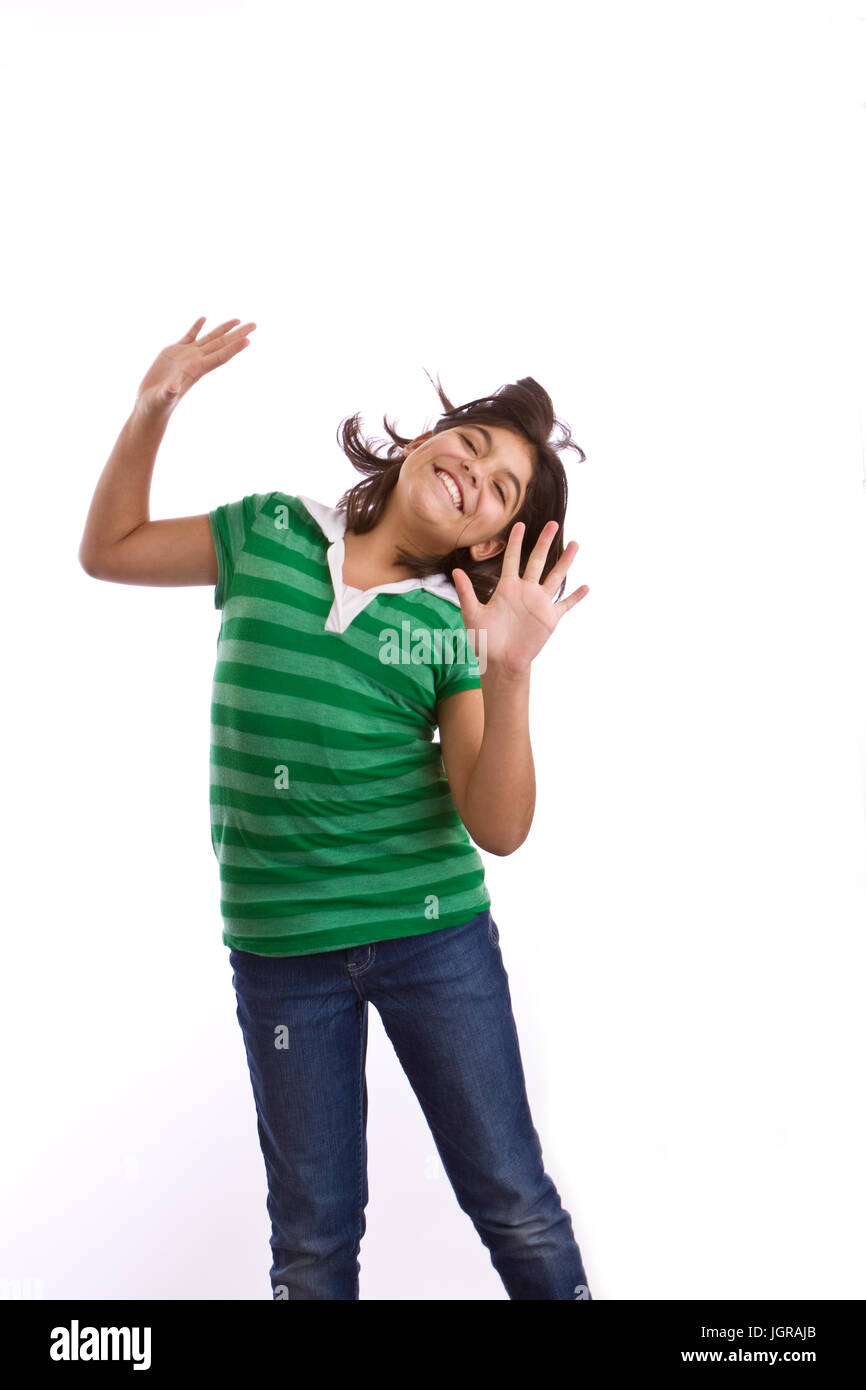 Hispanic young girl smiling and dancing isolated on white Stock Photo ...