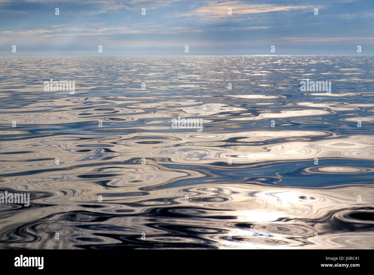 A smooth, glassy, empty sea off Anglesey, Wales, UK Stock Photo