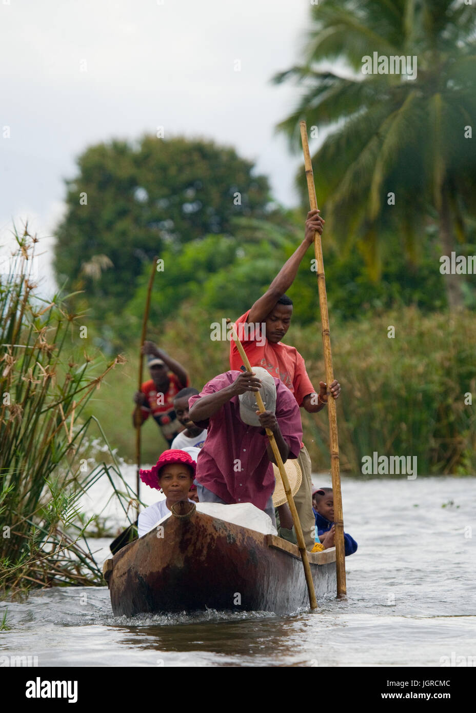 MADAGASCAR, MAROANTSETRA - SEPTEMBER 13, 2010: People from villages transport freights by boats on channels. Stock Photo