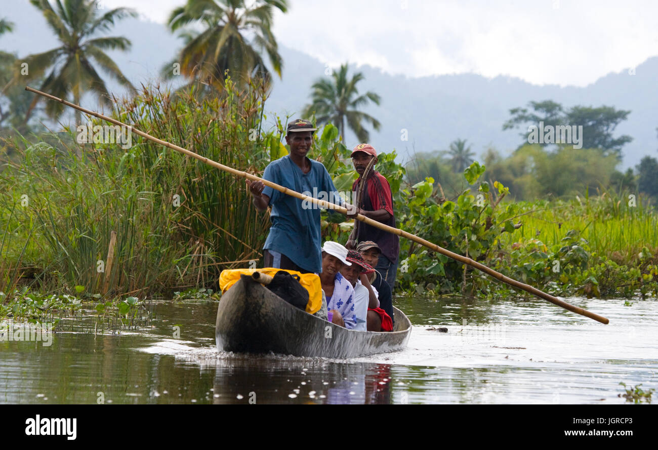 MADAGASCAR, MAROANTSETRA - SEPTEMBER 13, 2010: People from villages transport freights by boats on channels. Stock Photo