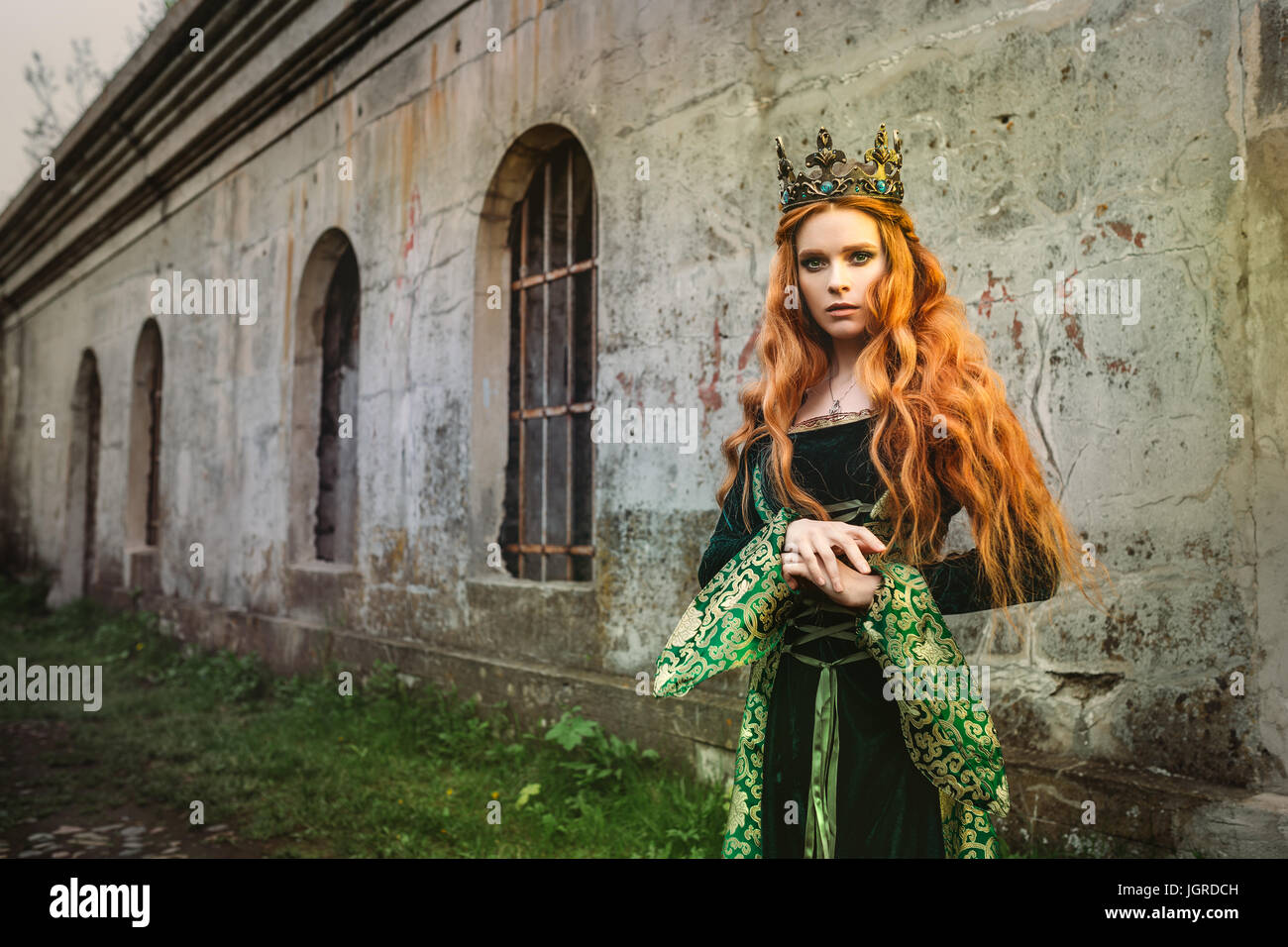 Portrait of a beautiful red-haired woman in green medieval 