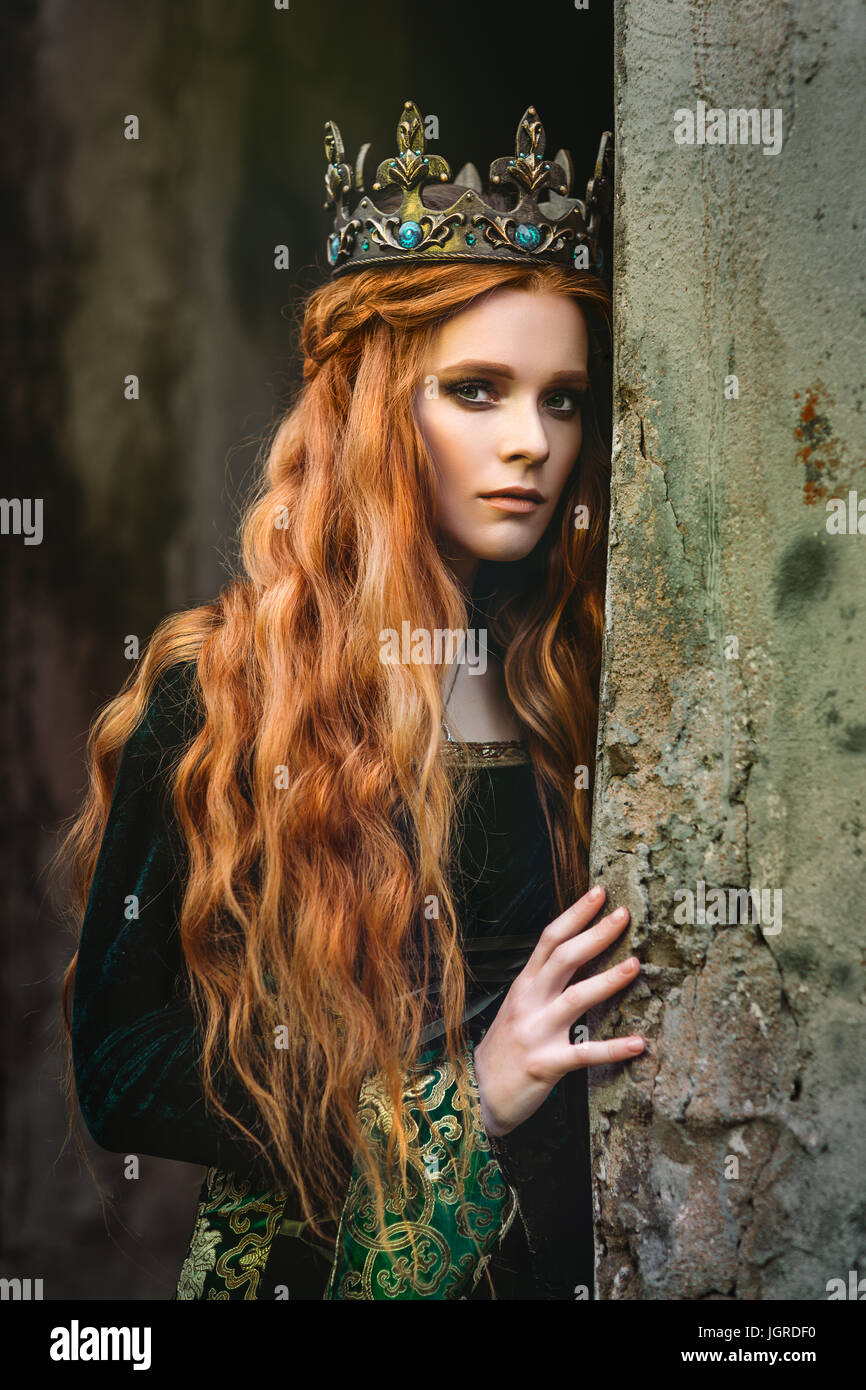 Red-haired woman in a green medieval dress near the castle Stock Photo -  Alamy