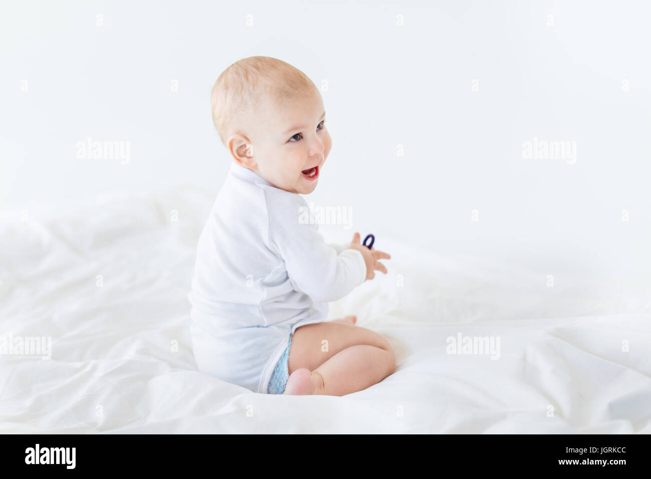 Happy baby boy sitting on hi-res stock photography and images - Alamy