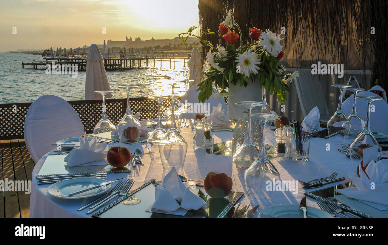 Wedding table with a beautiful sea view. Luxury wedding reception by the sea.   Wedding reception place ready for guests. Stock Photo