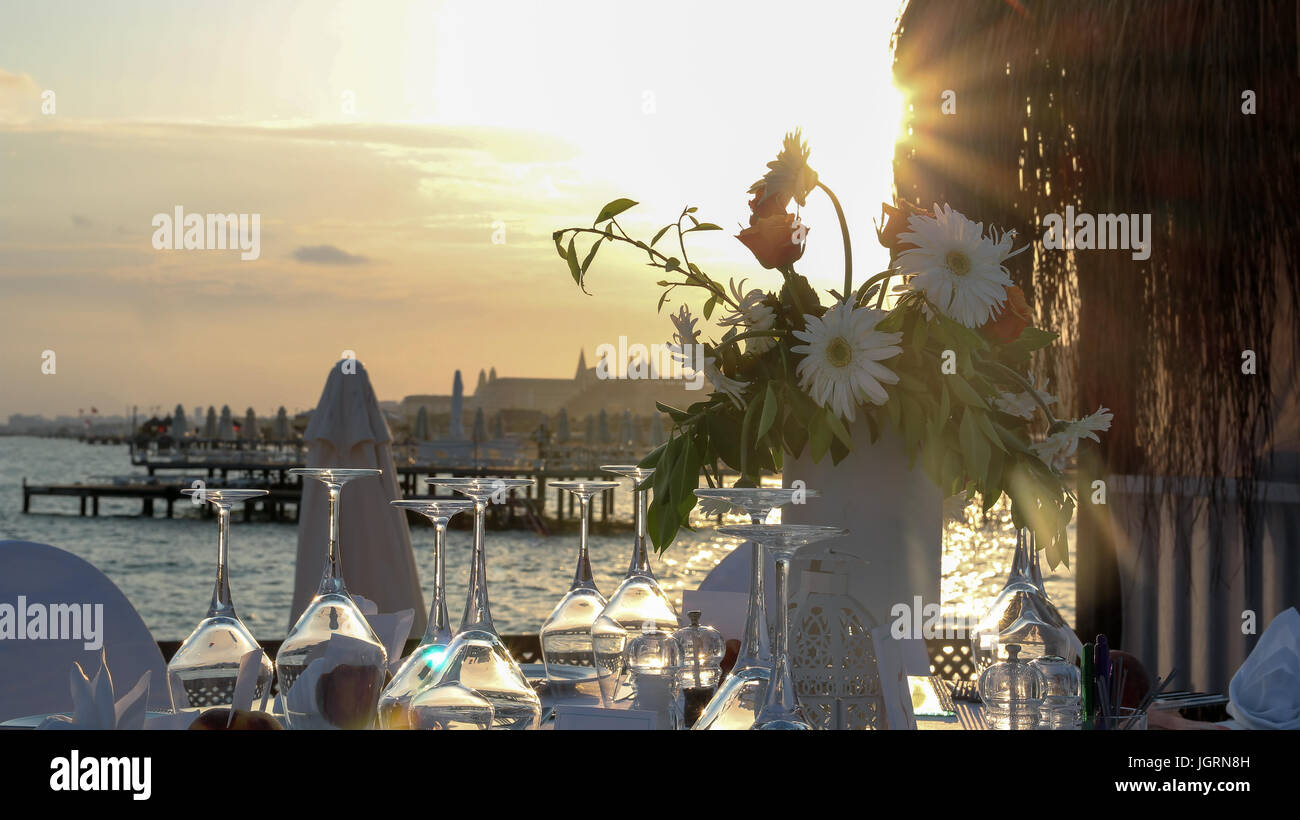 Wedding table with a beautiful sea view. Luxury wedding reception by the sea.   Wedding reception place ready for guests. Stock Photo