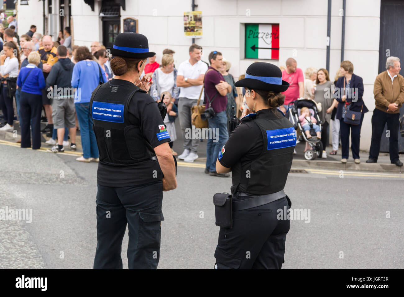 Female Police and Community Safety Officers or PCSO on duty providing support to the regular police at the Eisteddfod street parade in Llangollen Stock Photo