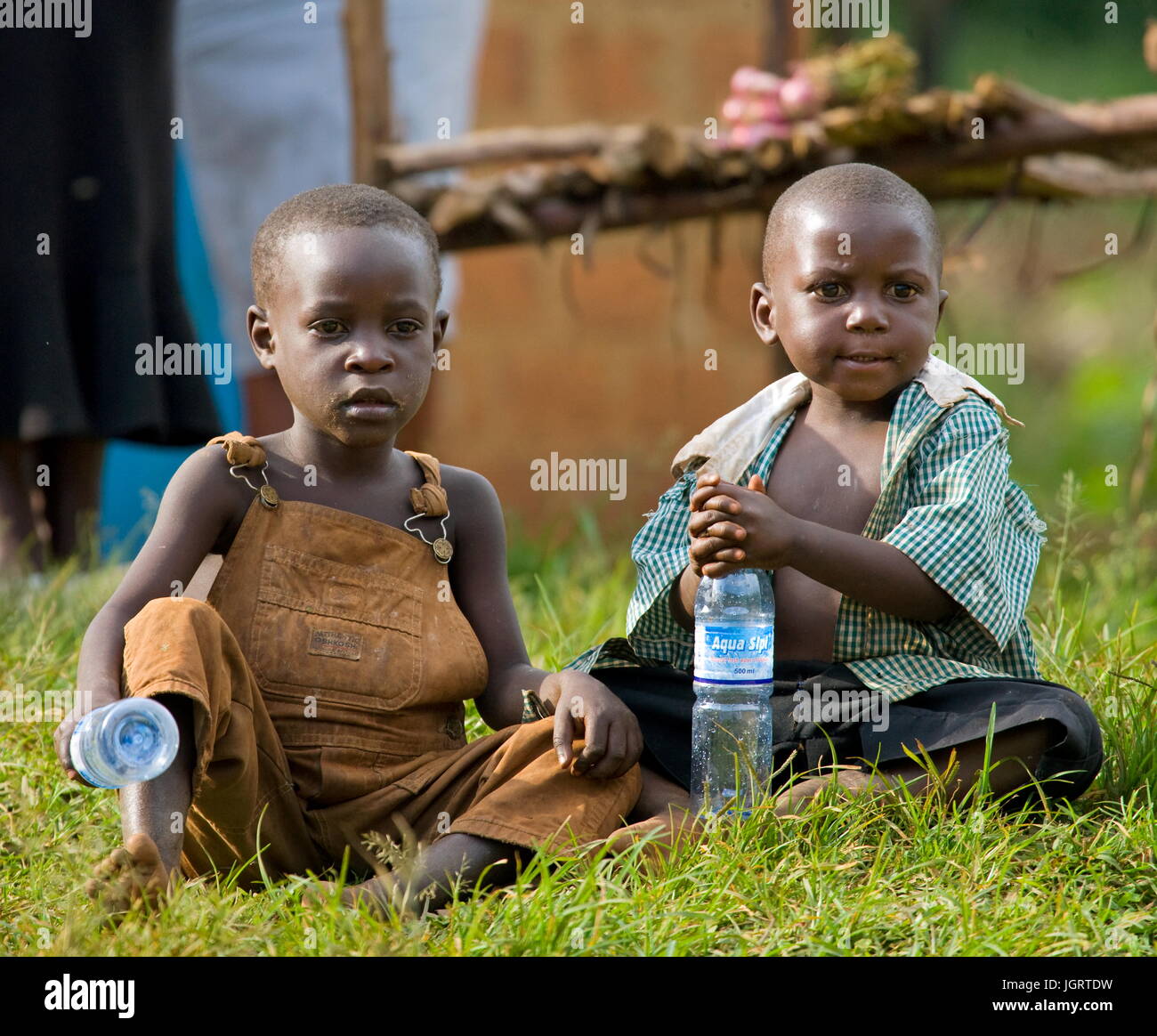 KISORO, UGANDA, AFRICA - DECEMBER 12, 2008: Kisoro. Uganda. Africa. Village children are sitting at the roadside.12 December, 2008. Kisoro. Uganda. Stock Photo