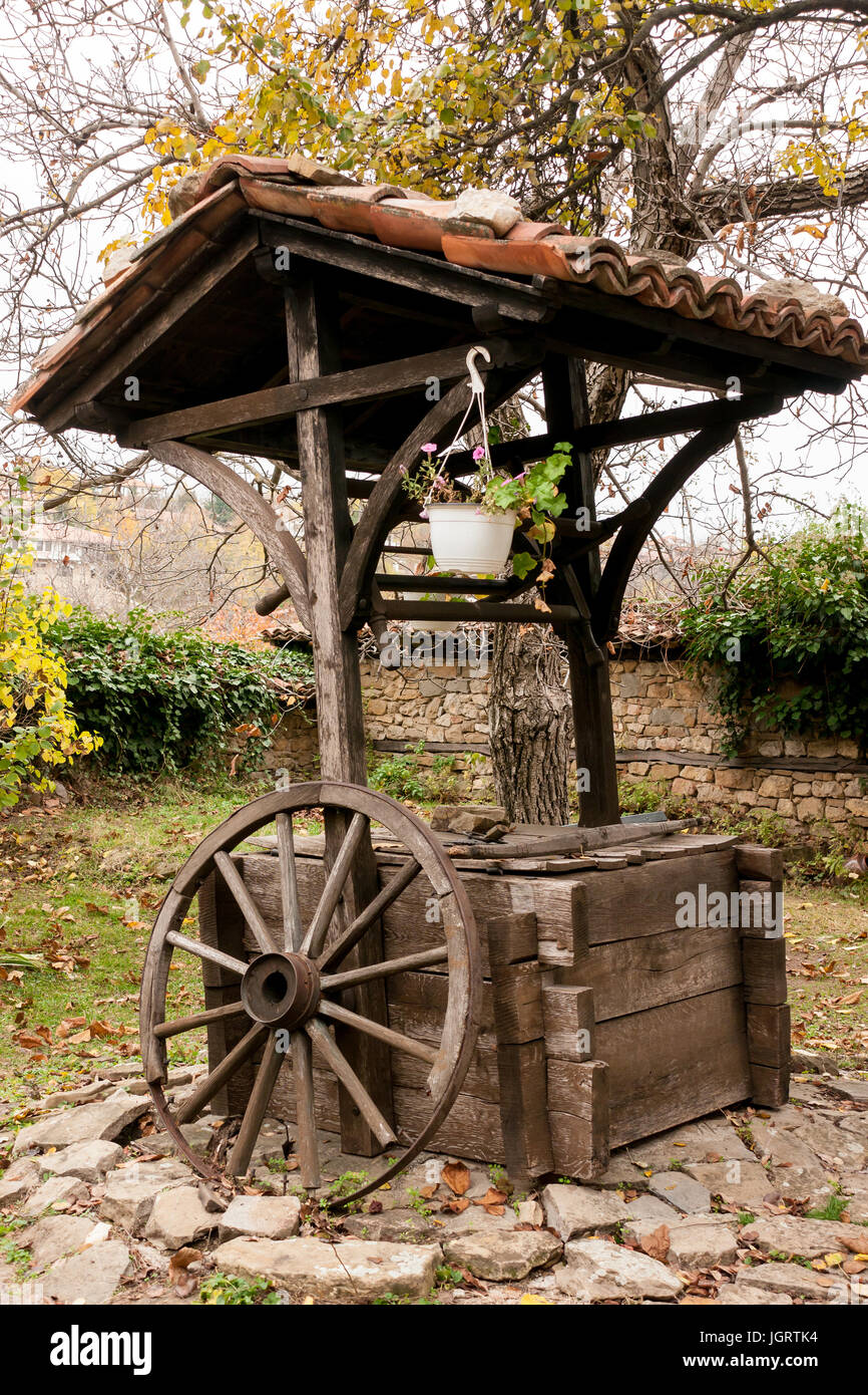 Water well with tiled roof in the garden a typical old house in Svishtov, Bulgaria Stock Photo