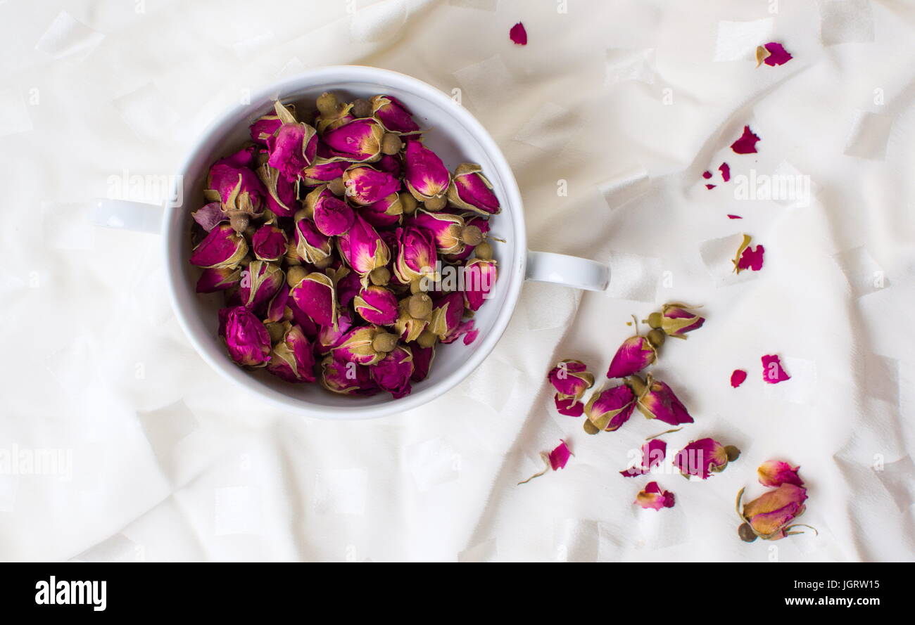 Small rose tea flowers in a cup top view Stock Photo