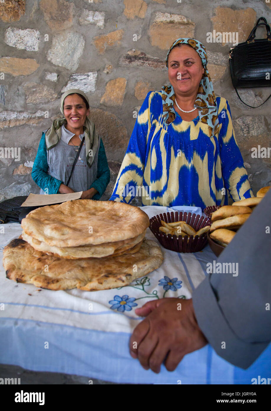 Tajik women selling bread in the market border with Afghanistan, Central Asia, Ishkashim, Tajikistan Stock Photo