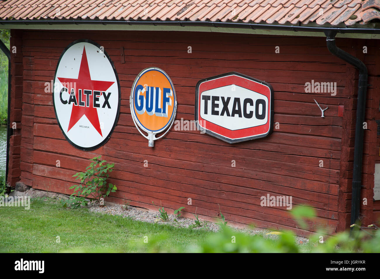 ENAMEL SIGNS for international gasoline companies -on a cottage wall -no longer active in Sweden -2017 Stock Photo