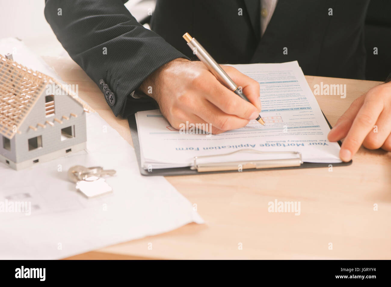 Businessman signing a mortgage contract of a sale for a new house Stock ...