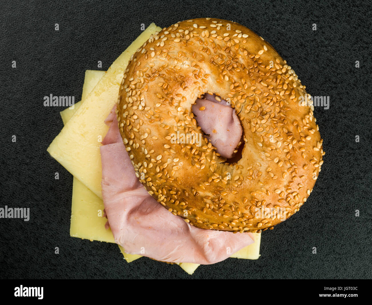 Ham and Cheese Toasted Bagel on a Black Background Stock Photo