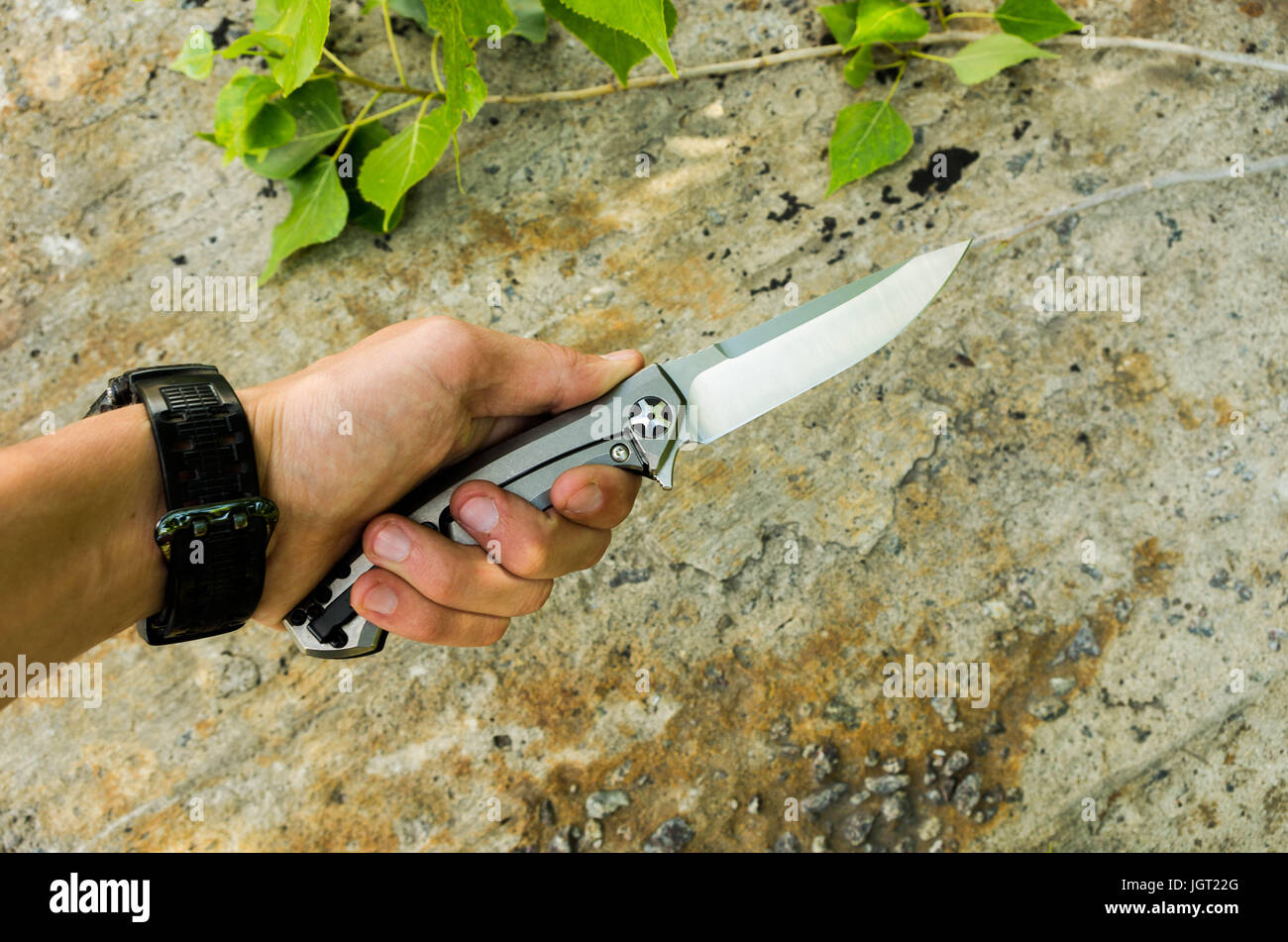 Dangerous knife is sandwiched in the man's left hand Stock Photo Alamy