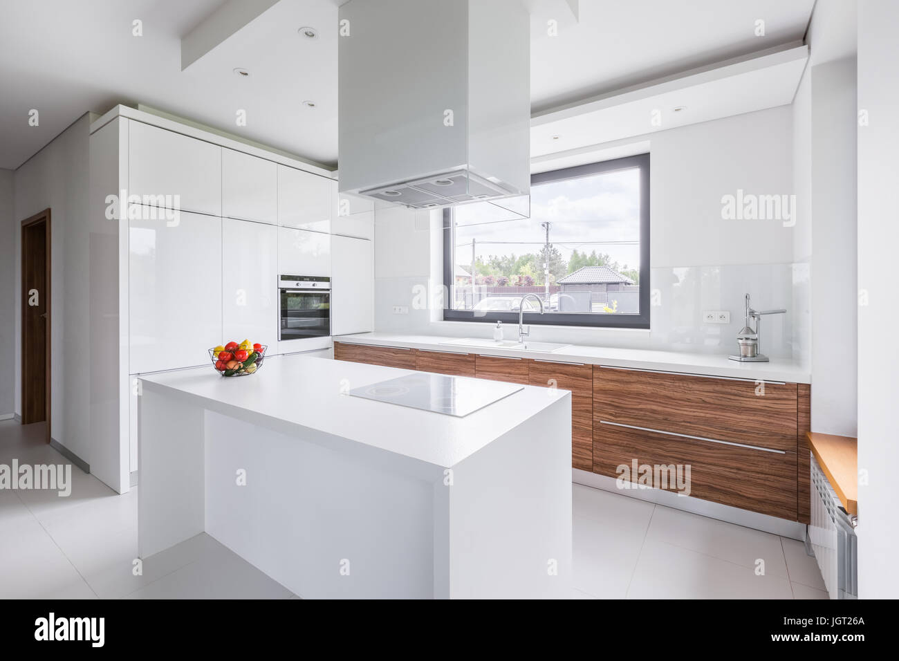 Modern, white kitchen with island and long countertop Stock Photo Alamy