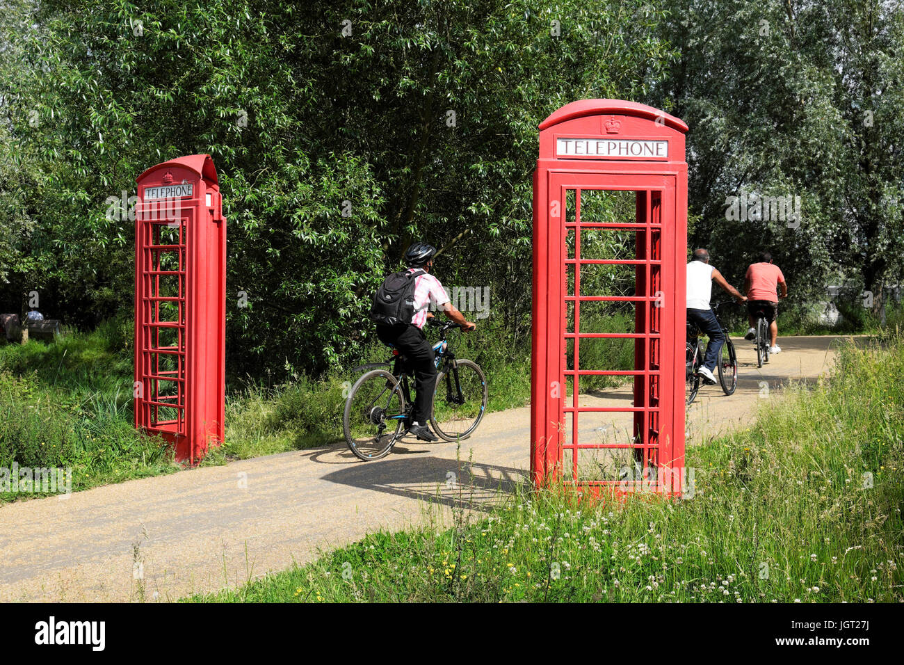 Red telephone box art installation split in half on either side of a path at the Queen Elizabeth Olympic Park Stratford England UK  KATHY DEWITT Stock Photo