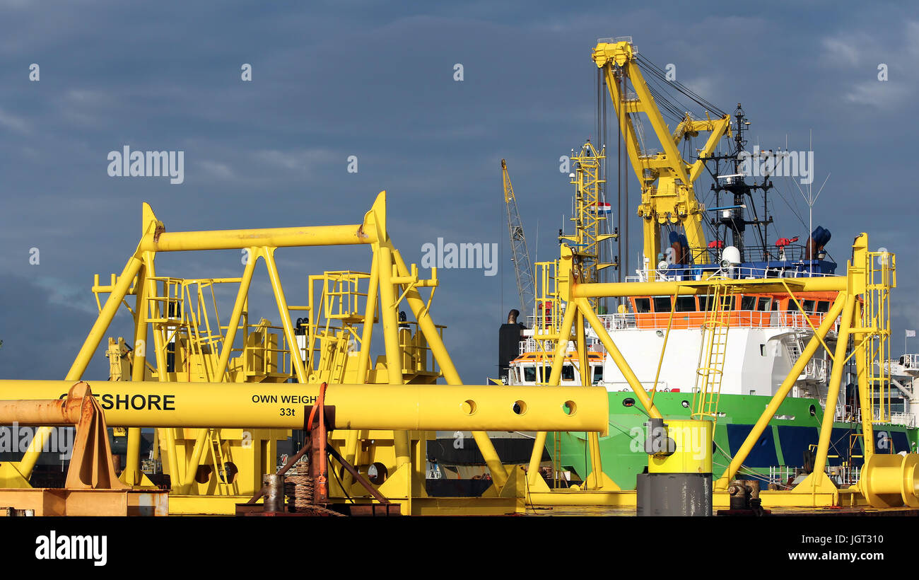 A crane vessel, crane ship or floating crane is a ship with a crane specialized in lifting heavy loads. Floating crane moored in port of Rotterdam. Stock Photo