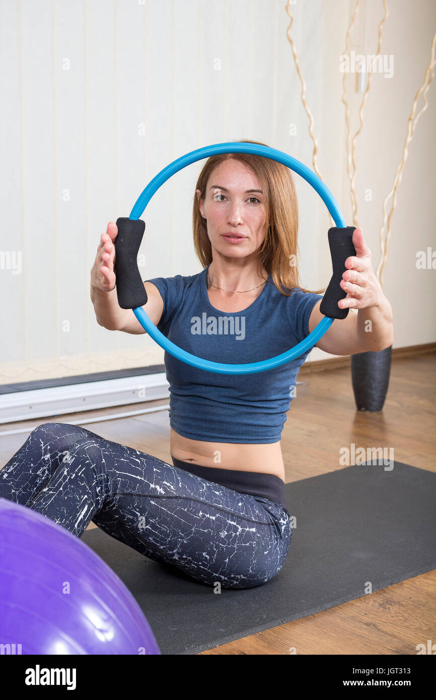 Middle Aged Woman Workout at Home. Pilates ring workout. Stock Photo
