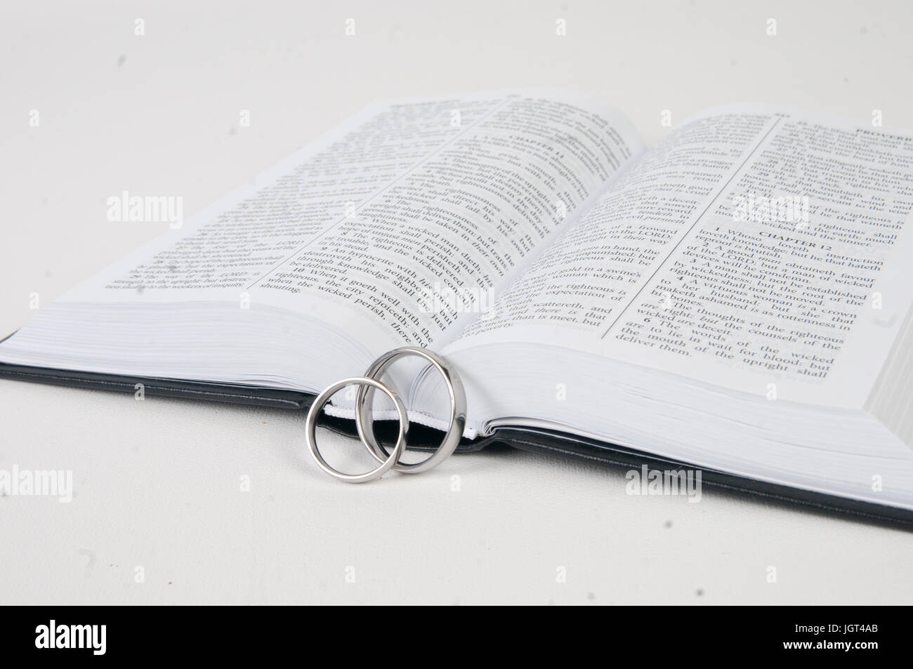 Wedding rings on bible. Marriage and faith make a perfect combination. Stock Photo