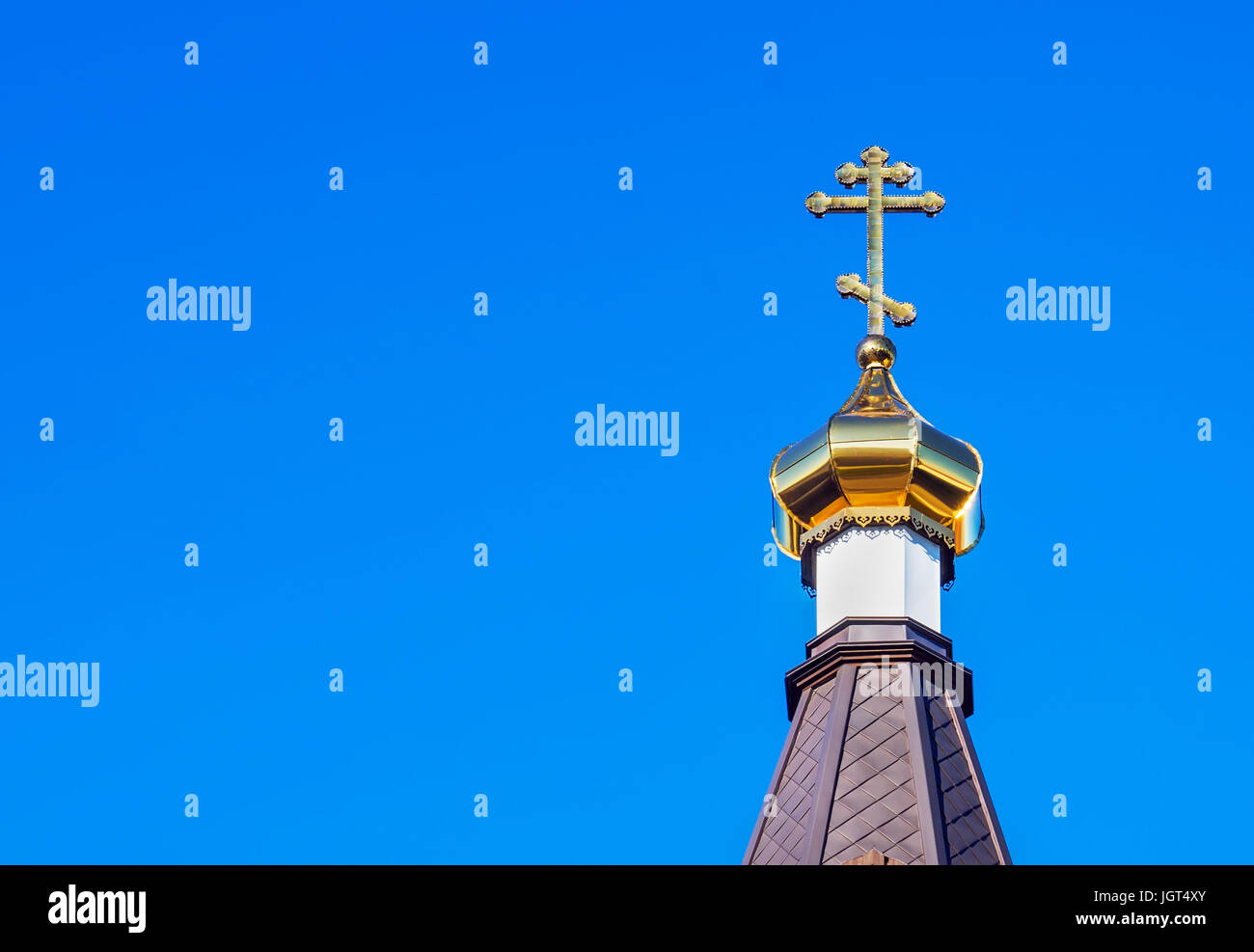The Golden dome of an Orthodox temple on background of blue sky and ...