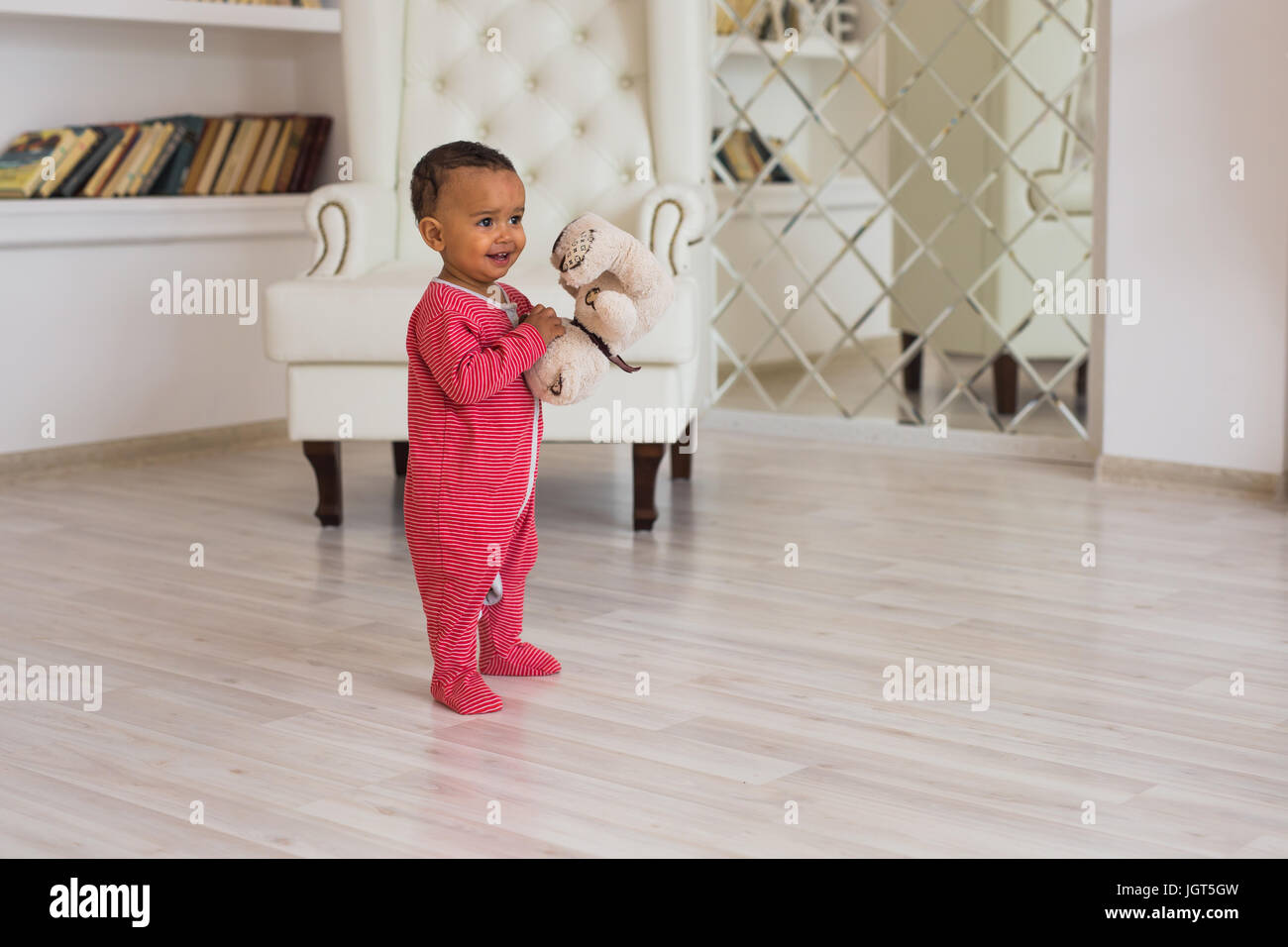 Happy baby boy playing with his teddy bear Stock Photo - Alamy