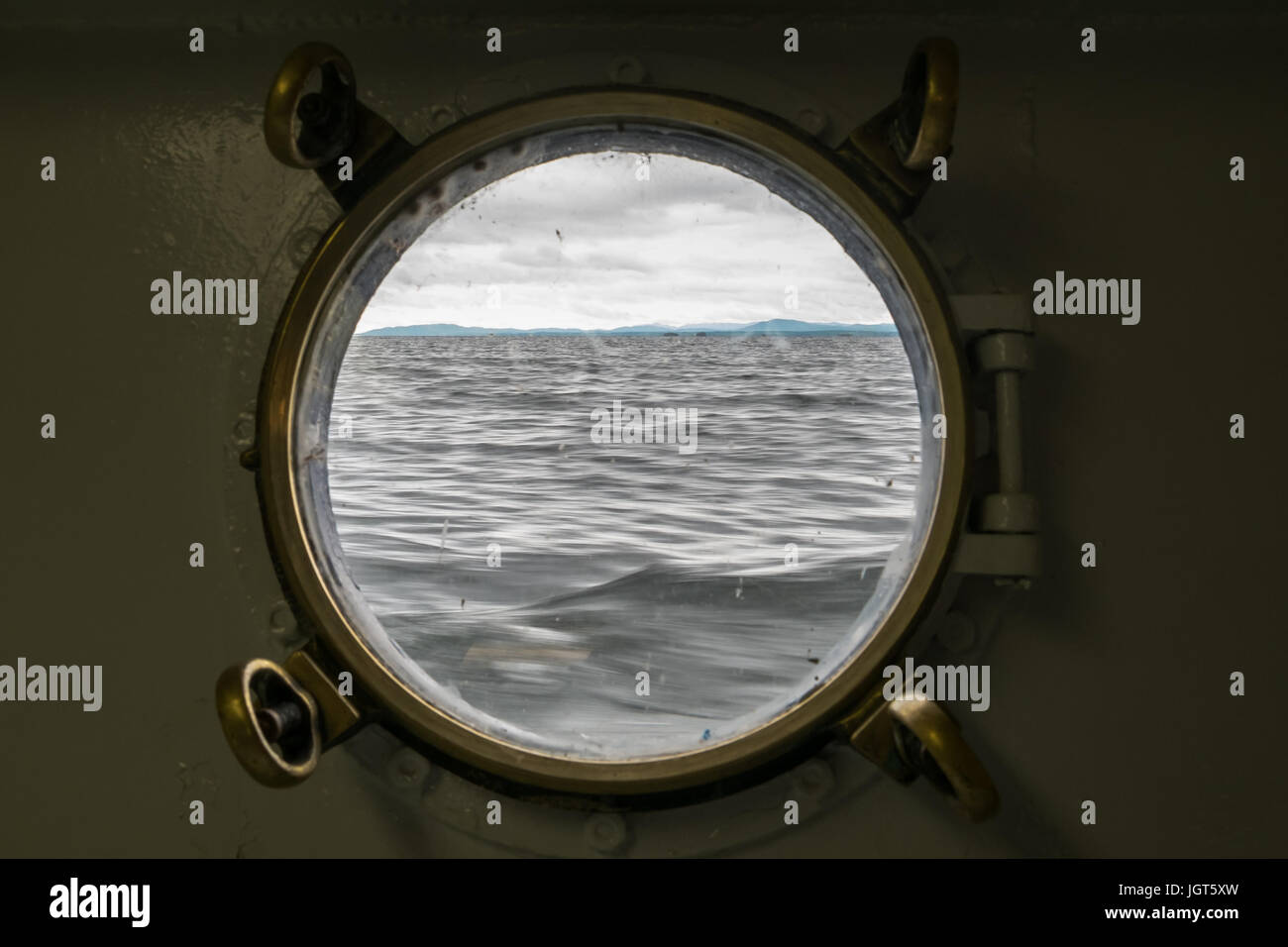 The sea as seen through a porthole in a ship Stock Photo