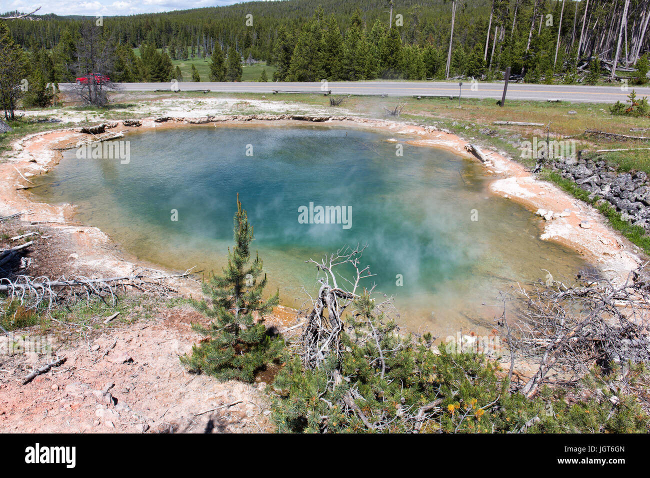 Leather Pool with the road nearby, as seen from the Fountain Paintpot Trail in the Lower Geyser Basin in Yellowstone National Park Stock Photo