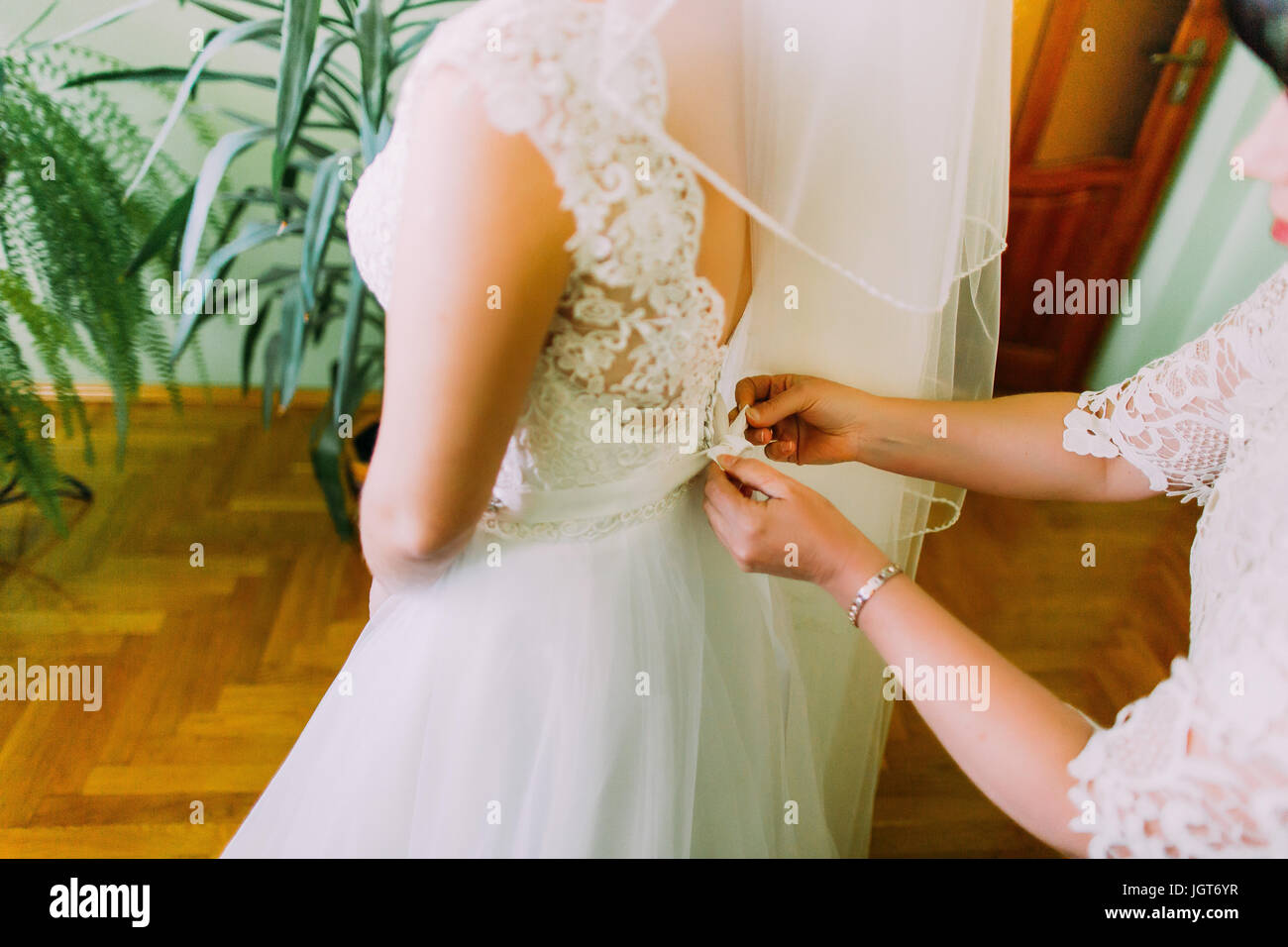 Dressing up the bride before wedding ceremony Stock Photo Alamy