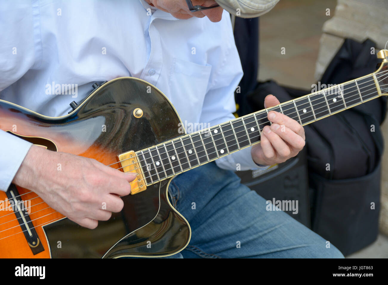 Close-up of a street musician playing guitar in Cambridge Cambridgeshire England Stock Photo