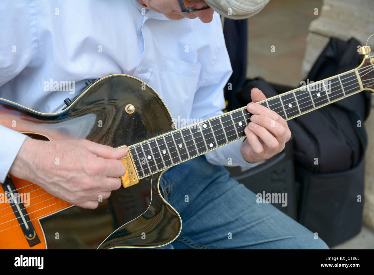 Close-up of a street musician playing guitar in Cambridge Cambridgeshire England Stock Photo