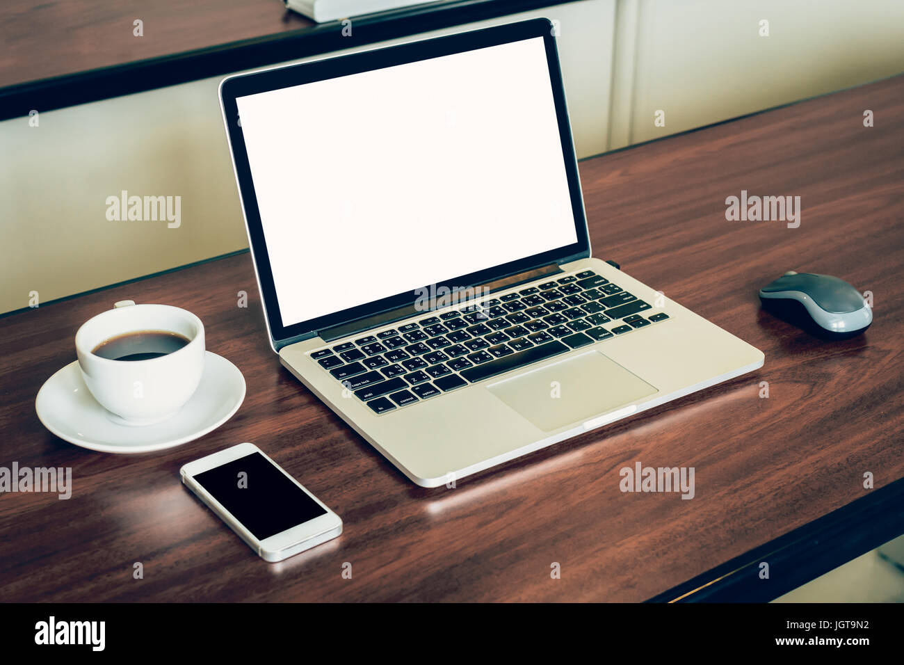 Laptop computer and white blank screen on wood table in office Stock ...