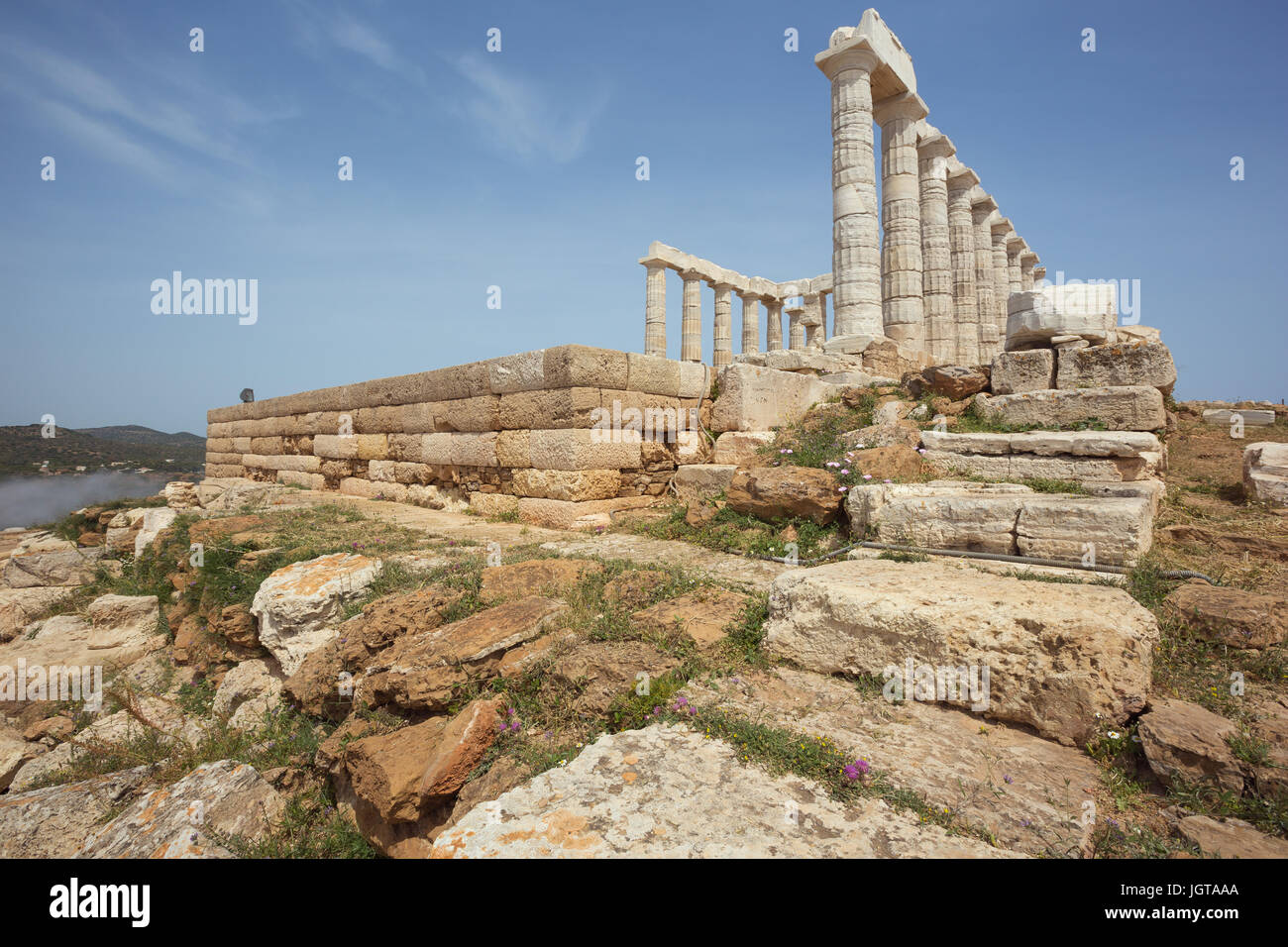 Low camera viewpoint at the Poseidon temple with sea fog in the background Stock Photo